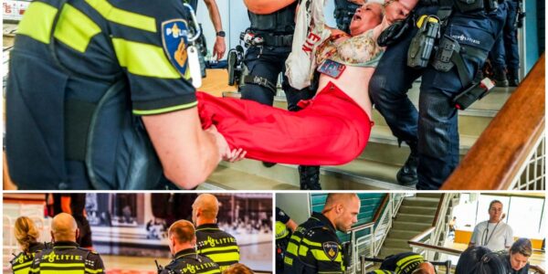 Speech minister verstoord door activisten, meerdere mensen door de politie uit de zaal verwijderd.